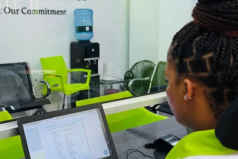 Staff member reviewing a loan application on a laptop