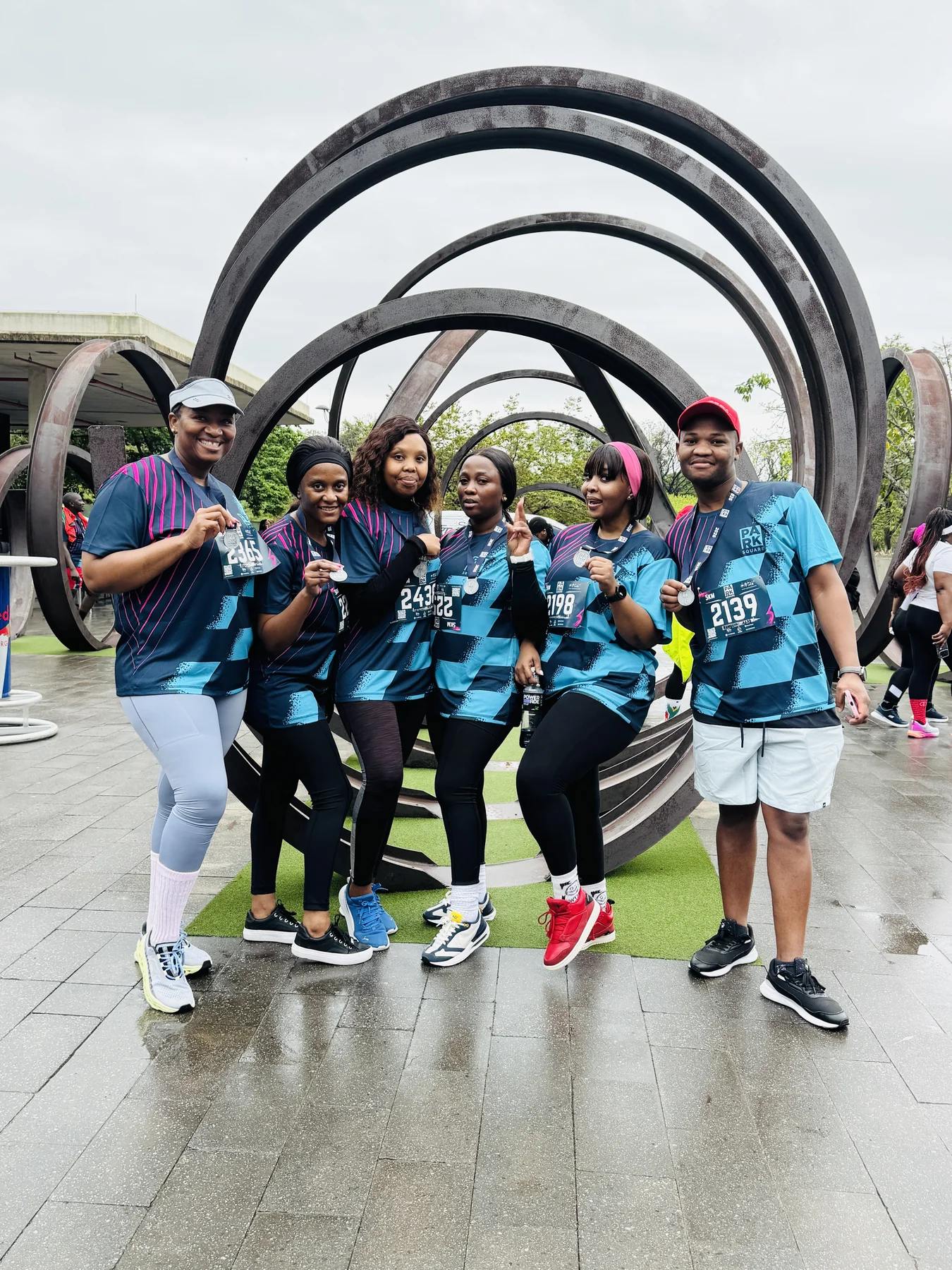 Esihlentu team members celebrating together after the Park Square 5K Run